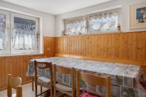 a dining room with a table and chairs at Casa della Rosina in Bresimo