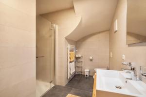 a bathroom with a sink and a shower at Parigger Apt Enzian in Racines +15 photos