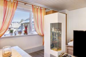 a room with a window with curtains and a table at Ferienwohnung bei Will in Stützerbach