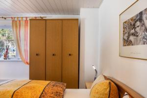 a bedroom with a bed and a cabinet at Ferienwohnung bei Will in Stützerbach