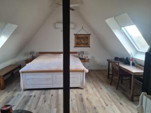 a bedroom with a bed and a table in a attic at Maisonette-Wohnung in Gladbeck in Gladbeck