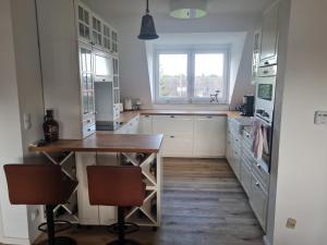 a kitchen with a wooden table and a window at Maisonette-Wohnung in Gladbeck in Gladbeck