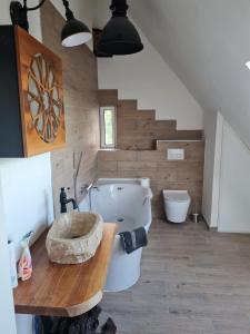a bathroom with a tub and a sink and a toilet at Maisonette-Wohnung in Gladbeck in Gladbeck +8 photos