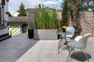 a patio with two chairs and a table on a patio at Ferienwohnungen Eulenspiegel in Breisach am Rhein