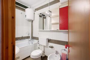 a bathroom with a toilet and a sink and a tub at Appartamenti Larice Pila in Pila +43 photos