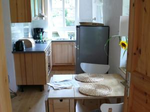 a small kitchen with a table and a refrigerator at Alte Wassermühle in Salem +36 photos