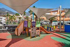 a playground with a slide in a park at El Pisito de Momo in Candelaria