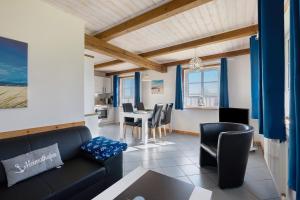 a living room with a couch and a table at Haus Möwe und Robbe in Dagebüll