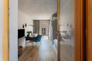 a living room with a table and a blue chair at Decanter House in Borgomanero