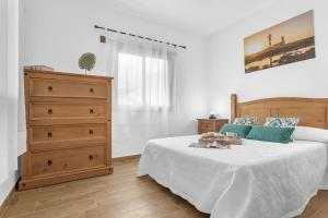 a bedroom with a large bed and a dresser at La Casilleta in Betancuría