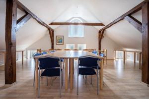 a dining room with a table and chairs at Herrenhaus Carolinenhof in Groß Plasten