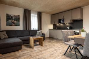 a living room with a couch and a table at Ferienwohnung Sonneck in Natz-Schabs +15 photos