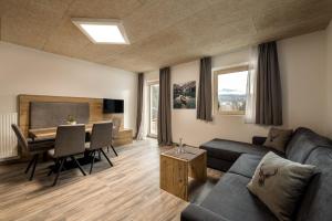 a living room with a couch and a table at Ferienwohnung Sonneck in Natz-Schabs