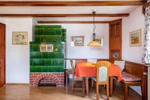 a dining room with a table and a fireplace at Hirschenhäusle in Sankt Märgen