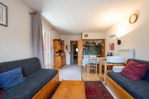 a living room with a couch and a table at Les arolles in Valloire