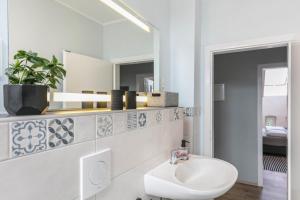 a bathroom with a toilet and a sink and a mirror at Ferienwohnung mit großem Garten in Lindow +17 photos