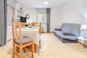 a living room with a table and a couch at Casa Raymond con piscina in Maçanet de la Selva