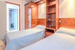 a bedroom with two beds and a mirror at Casa Raymond con piscina in Maçanet de la Selva +21 photos