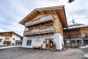 a wooden building with a balcony on top of it at Seppnerhof Ferienwohnung Enzian in Moso