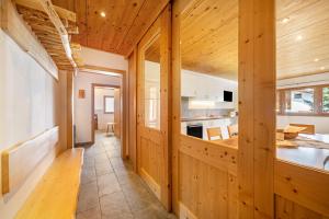 a kitchen with wooden walls and a dining room at Seppnerhof Ferienwohnung Enzian in Moso