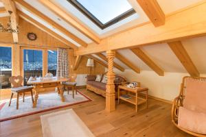 a living room with a vaulted ceiling with a skylight at Ferienwohnung Bergkristall in Mittenwald +17 photos