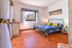 a bedroom with a bed and a window at Trilocale Fiordaliso in Stintino