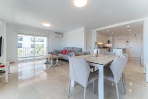 a dining room and living room with a table and chairs at Paraiso in Fuengirola