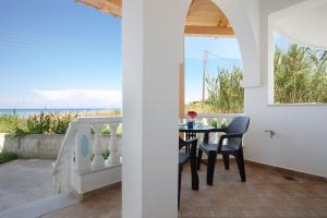 a dining room with a table and a view of the ocean at Apartment Vorrisi in Alykes