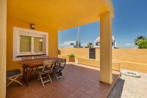 a patio with a table and chairs on a balcony at La Cala in Cabo de Palos