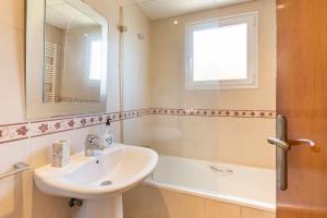 a bathroom with a sink and a mirror and a tub at La Cala in Cabo de Palos +22 photos