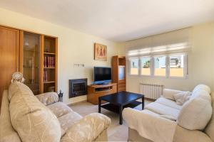 a living room with two couches and a tv at La Cala in Cabo de Palos