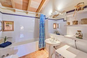 a bathroom with a sink and a tub and a toilet at Casa Martin in Calvià +27 photos
