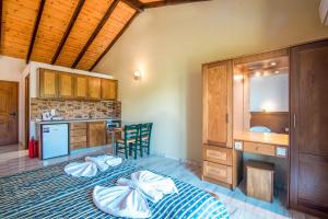 a kitchen with two beds and a desk and a sink at Mirage Arillas Studio Type C19 in Arillas