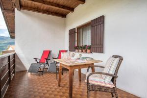 a table and chairs on the balcony of a house at Ferienwohnung 4 Vikoler in Vols am Schlern +27 photos