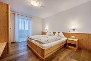 a bedroom with a large bed and a large window at Maurerhof Abendrot in Maranza