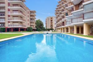 a large swimming pool in front of some apartment buildings at Javea Brisas Del Mar Cofisa in Jávea