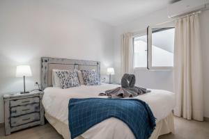 a bedroom with a large bed and a window at Alegria in Puerto del Carmen
