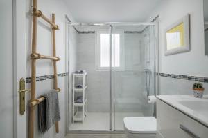 a bathroom with a shower and a toilet and a sink at Alegria in Puerto del Carmen +16 photos