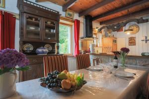 a kitchen with a table with a bowl of fruit on it at Gîte Ty Coz in Lanvellec