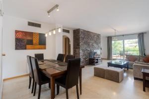 a dining room and living room with a table and chairs at Guadalmina Alta in Marbella