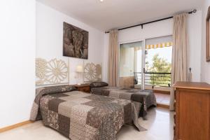 a hotel room with two beds and a window at Guadalmina Alta in Marbella +17 photos