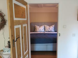 a bedroom with a bed with purple sheets and pillows at Fachwerktraum im Hof in Alheim