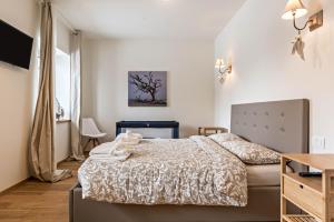 a small bedroom with a bed and a table at Wellness Lodge Riccardo in Santa Giuliana