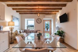a dining room and living room with a table and chairs at Wellness Lodge Riccardo in Santa Giuliana