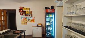 a coca cola refrigerator in a room with a counter at Penzion Bobas in Jindřichŭv Hradec