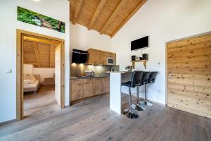 una cucina con bancone e sedie in una stanza di Eggerhof Suite a Verano