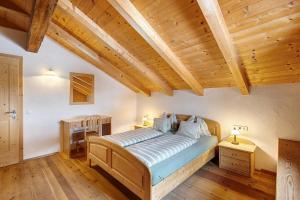 a bedroom with a bed and a wooden ceiling at Plazores in San Vigilio Di Marebbe