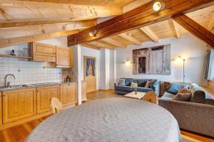 a kitchen and living room with a couch and a table at Plazores in San Vigilio Di Marebbe