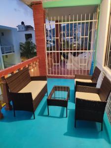 a balcony with two chairs and a table at Hotel Casa Lucina in Zihuatanejo