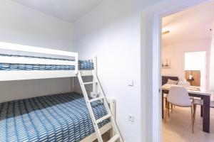 a bedroom with a bunk bed and a desk with a table at El Castañar de Ceubia in Arenas de San Pedro